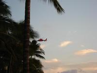 Sunset Waikiki Beach... see the helicopter there was an accident in a dinner cruise boat that night , the mast of the sailboat fell on passengers and killed one of them.